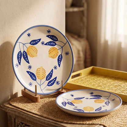 Botanical ceramic plate with yellow lemon-inspired flowers and blue leaf pattern