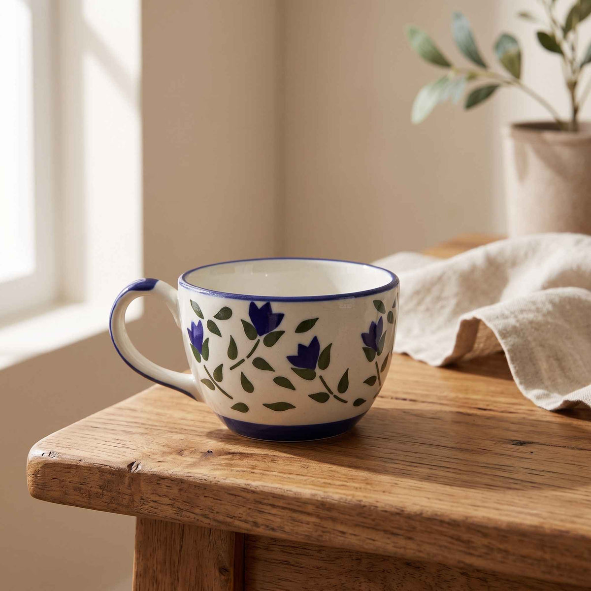 Floral ceramic bowl with handle in blue and white design by Craftriti